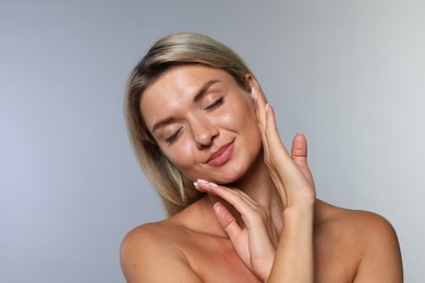 Photo of Cosmetology. Beautiful woman with perfect skin on grey background