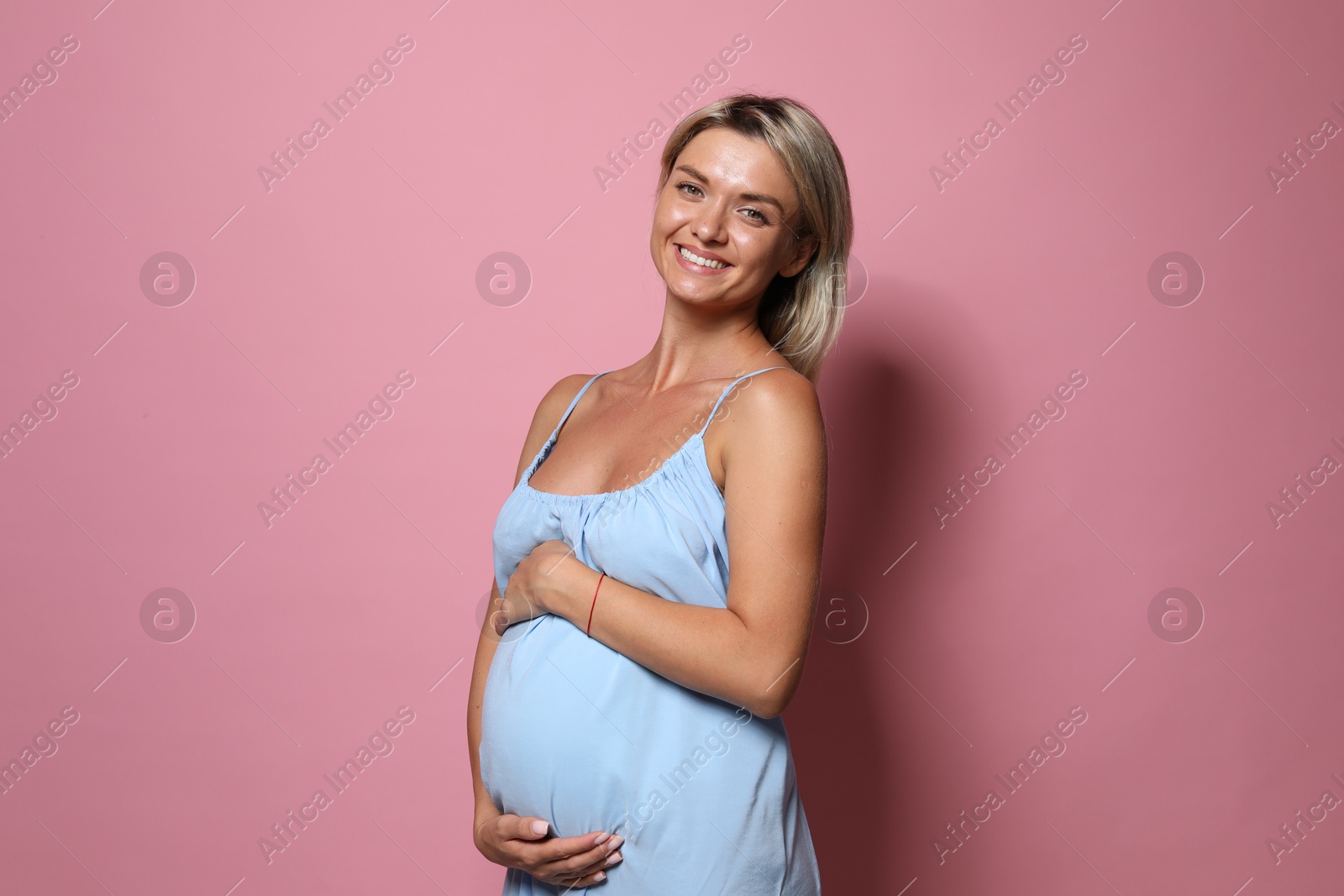 Photo of Portrait of beautiful pregnant woman on pink background