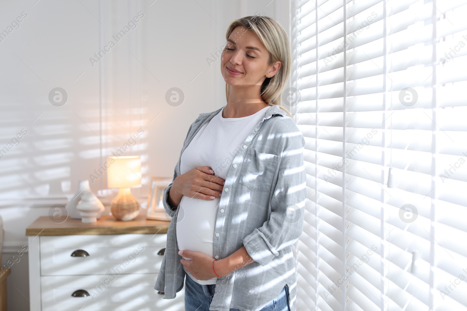 Photo of Portrait of beautiful pregnant woman at home