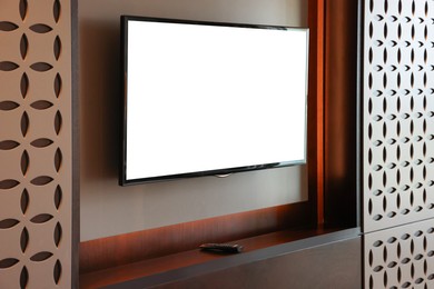 Photo of Tv set mounted on wall in room