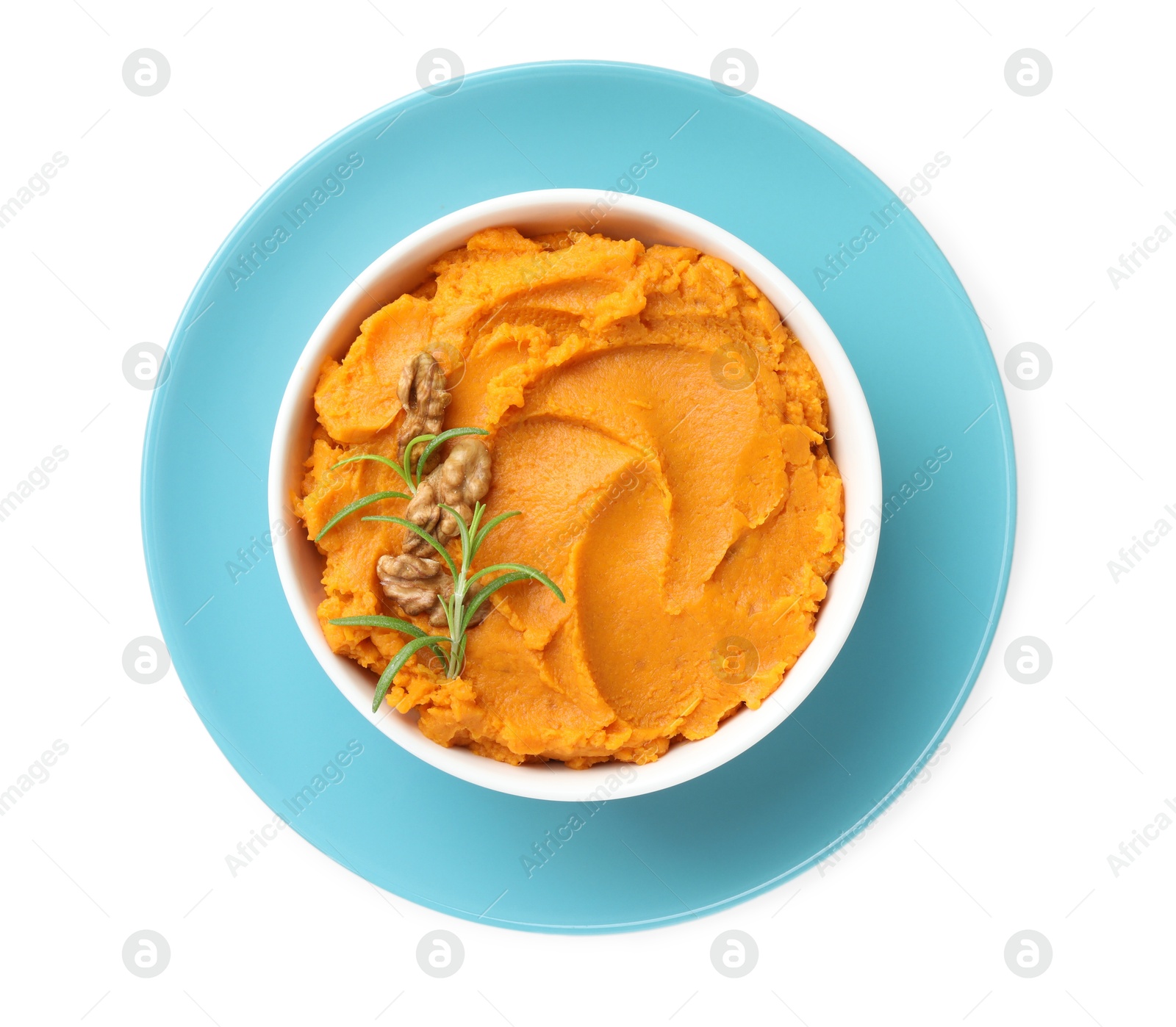 Photo of Delicious mashed sweet potatoes with walnuts and rosemary in bowl isolated on white, top view