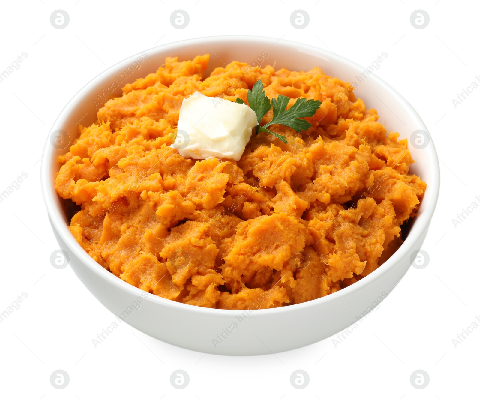 Photo of Delicious mashed sweet potatoes with butter and parsley in bowl isolated on white