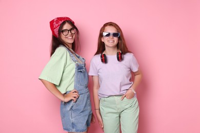 Photo of Happy teenage girls posing on pink background