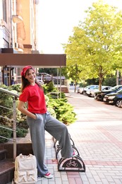 Photo of Happy teenage girl posing on city street