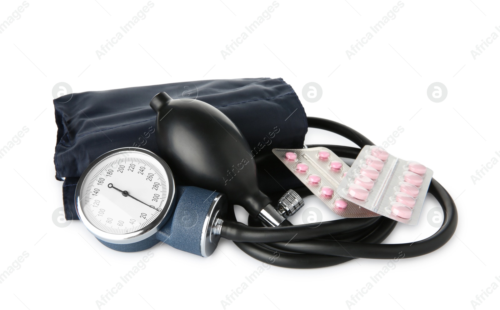 Photo of Blood pressure measuring device and pills in blisters isolated on white