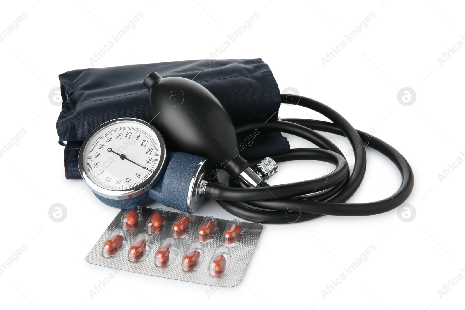 Photo of Blood pressure measuring device and pills in blister isolated on white