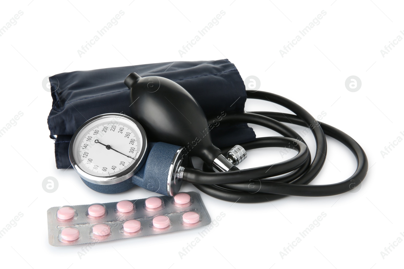 Photo of Blood pressure measuring device and pills in blister isolated on white