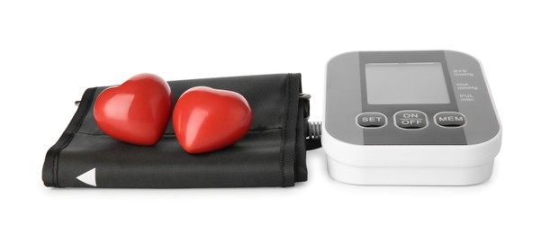 Blood pressure monitor and red decorative hearts isolated on white