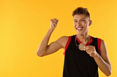 Happy winner with silver medal on yellow background. Space for text