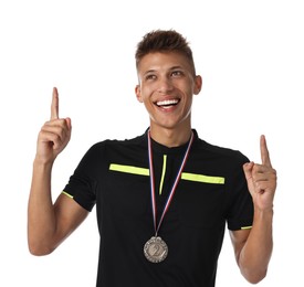 Happy winner with silver medal pointing upwards on white background