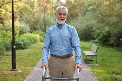 Senior man with walking frame in park