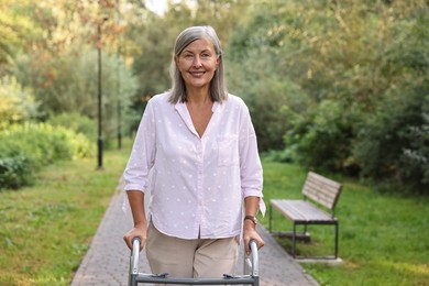 Senior woman with walking frame in park