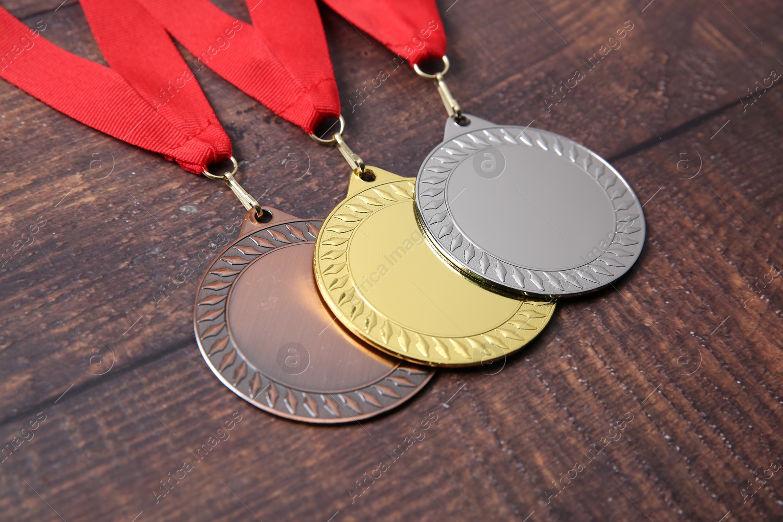 Photo of Golden, silver and bronze medals on wooden background, closeup