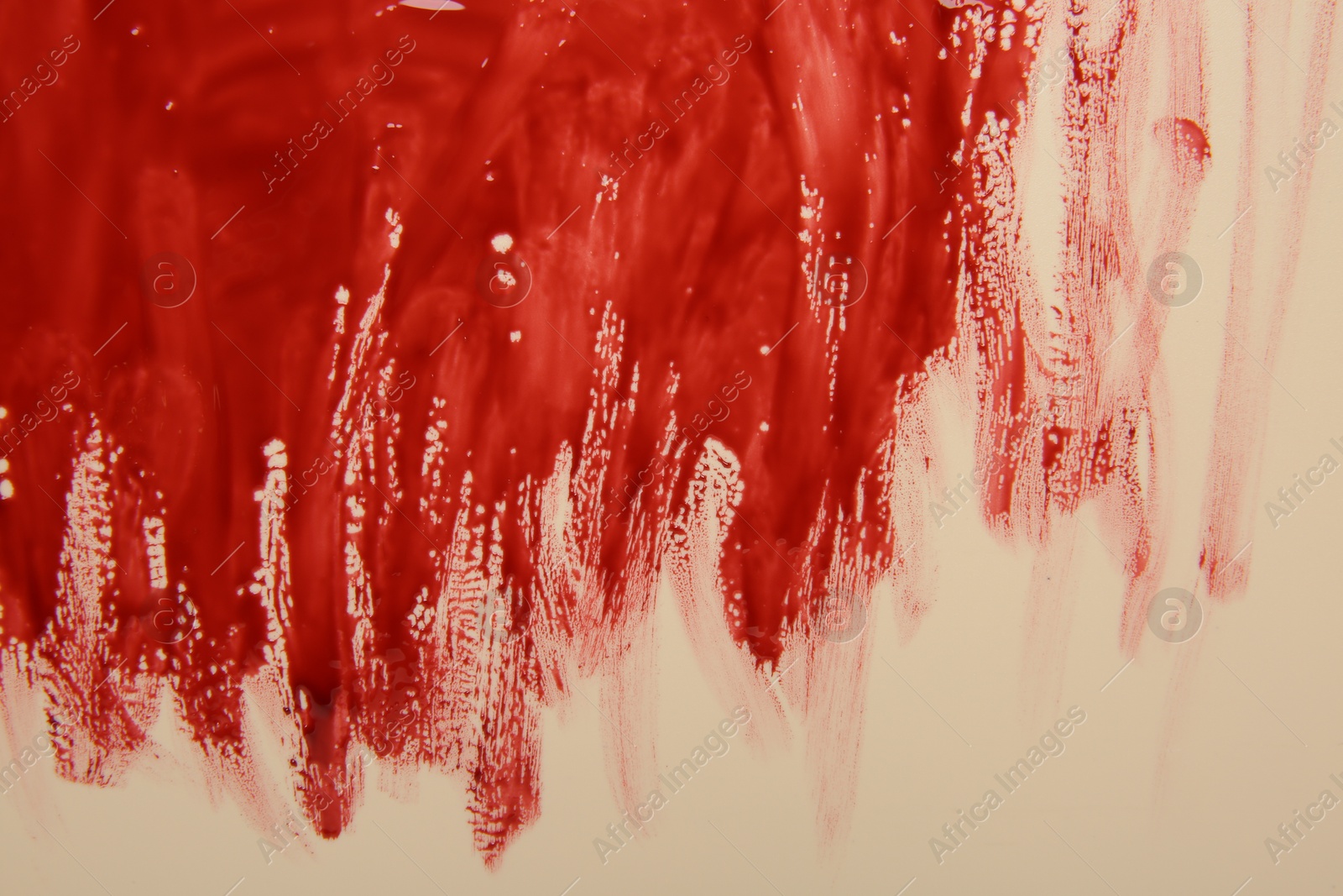 Photo of Red blood on beige background, top view