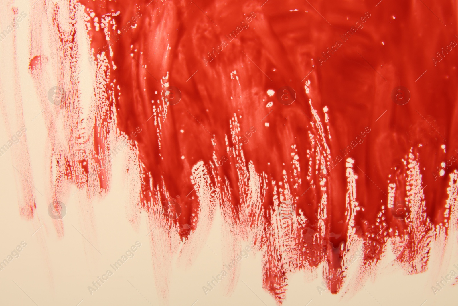 Photo of Red blood on beige background, top view