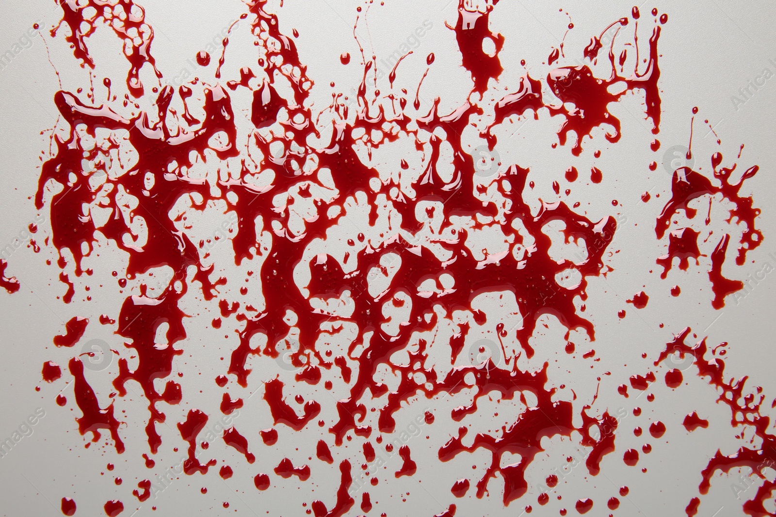 Photo of Splashes of blood on light grey background, top view