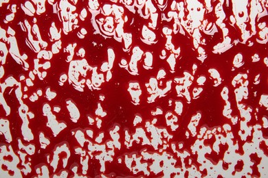 Photo of Splashes of blood on light background, top view