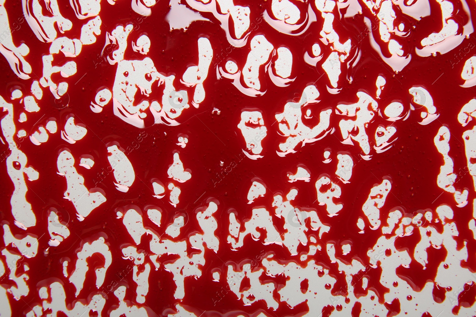 Photo of Red blood on white background, top view