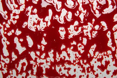 Red blood on white background, top view