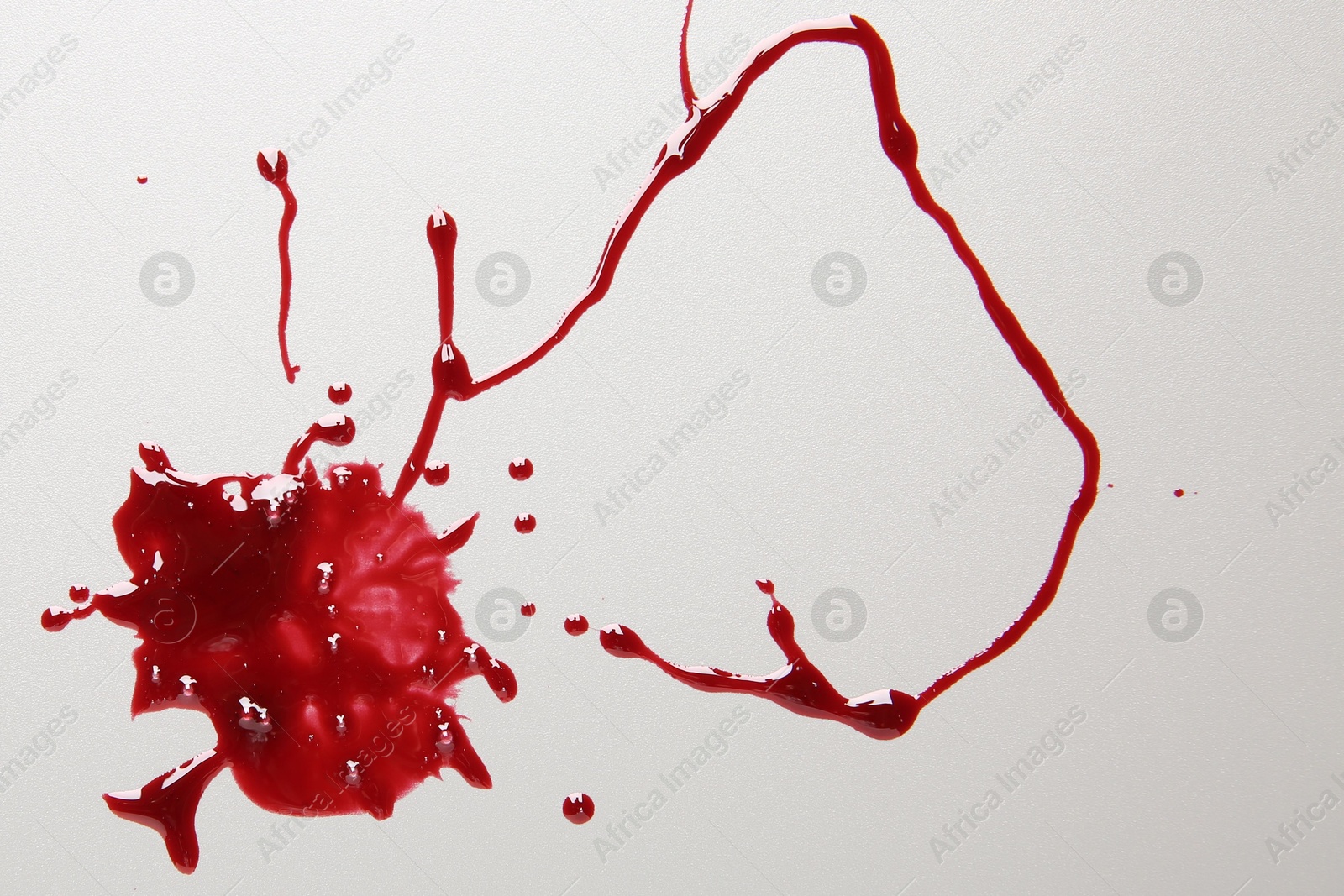 Photo of Splashes of blood on light grey background, top view