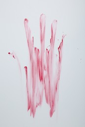 Photo of Bloody handprint on light background, top view