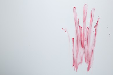 Photo of Bloody handprint on light background, top view. Space for text