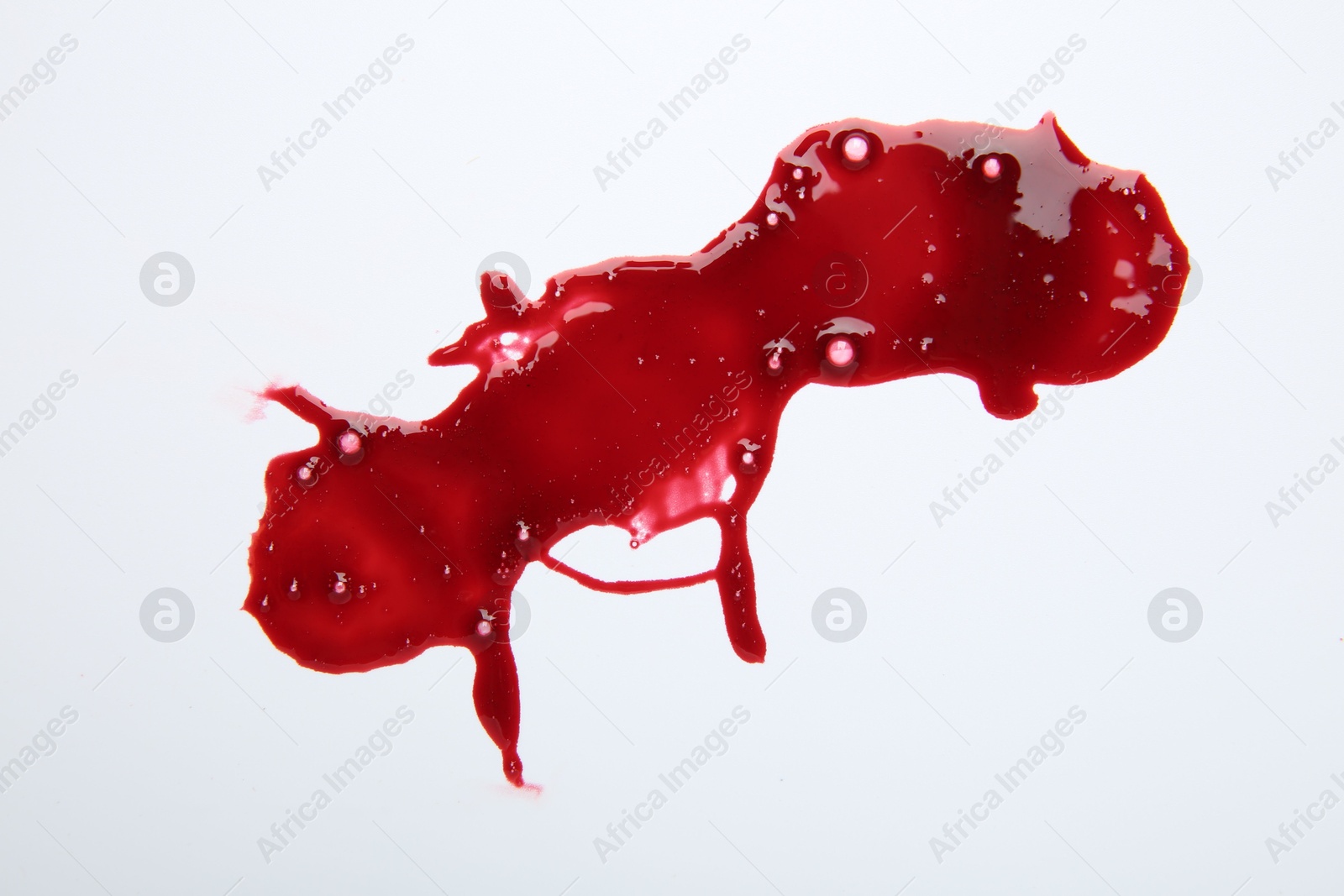 Photo of Stain of blood on white background, top view