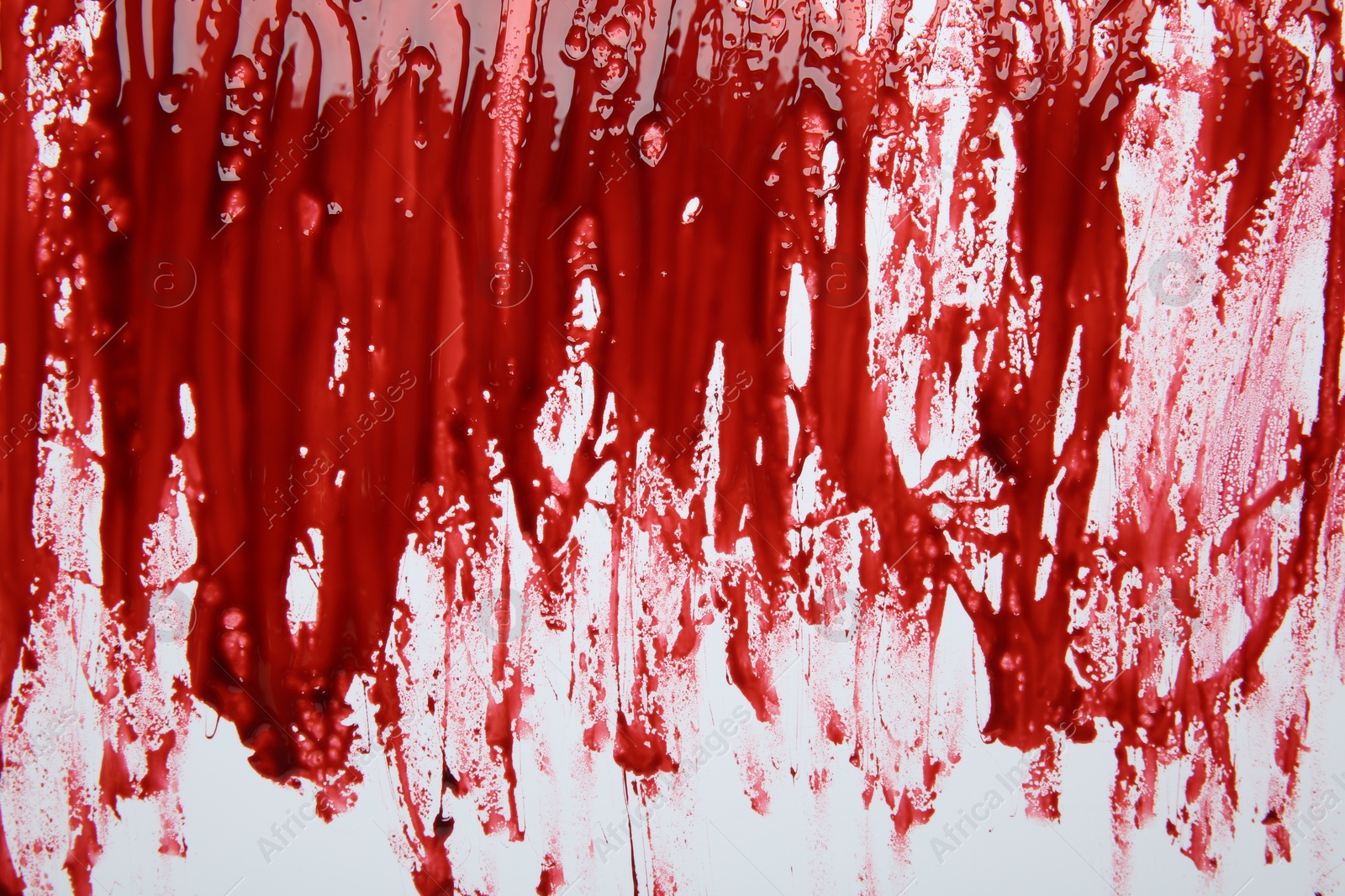 Photo of Red blood on white background, top view