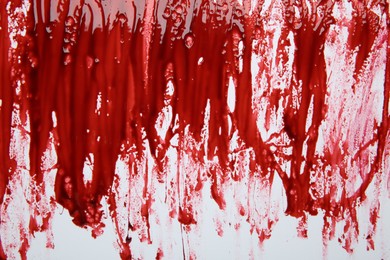 Red blood on white background, top view