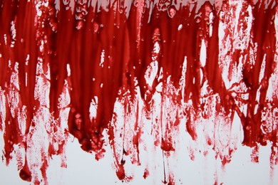 Photo of Red blood on white background, top view