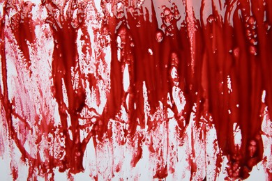 Photo of Red blood on white background, top view