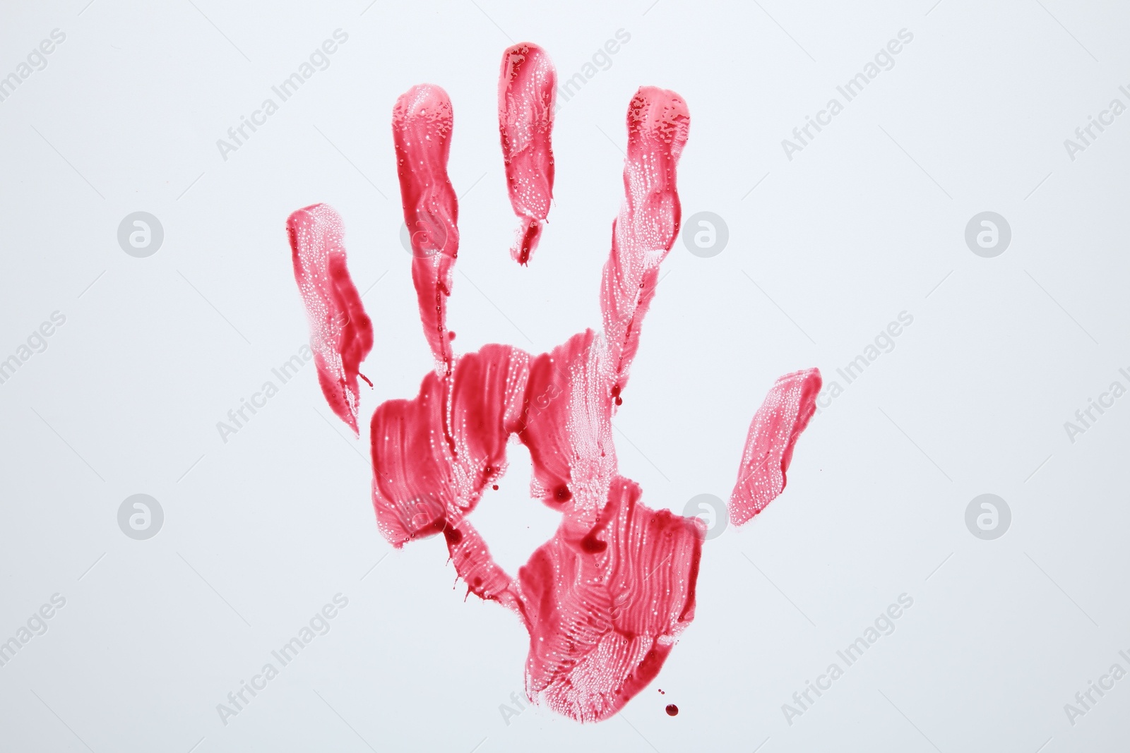 Photo of Bloody handprint on white background, top view