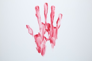 Photo of Bloody handprint on white background, top view