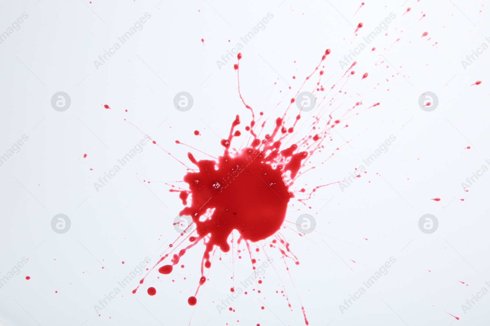 Photo of Splash of blood on white background, top view