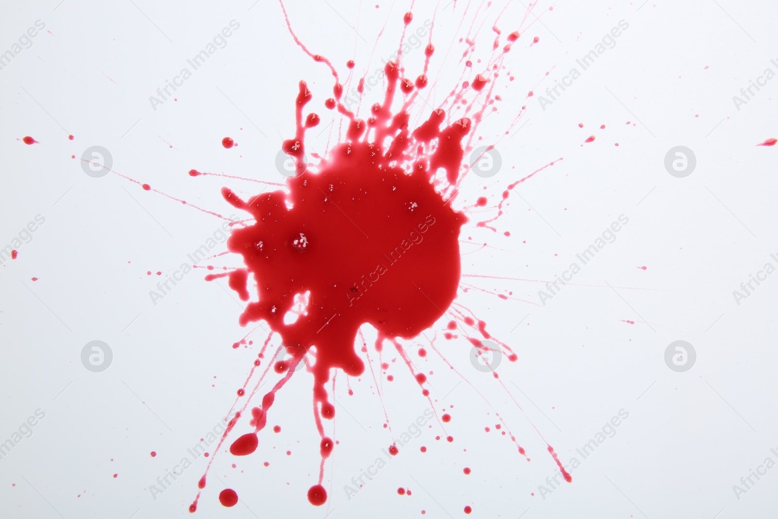 Photo of Splash of blood on white background, top view