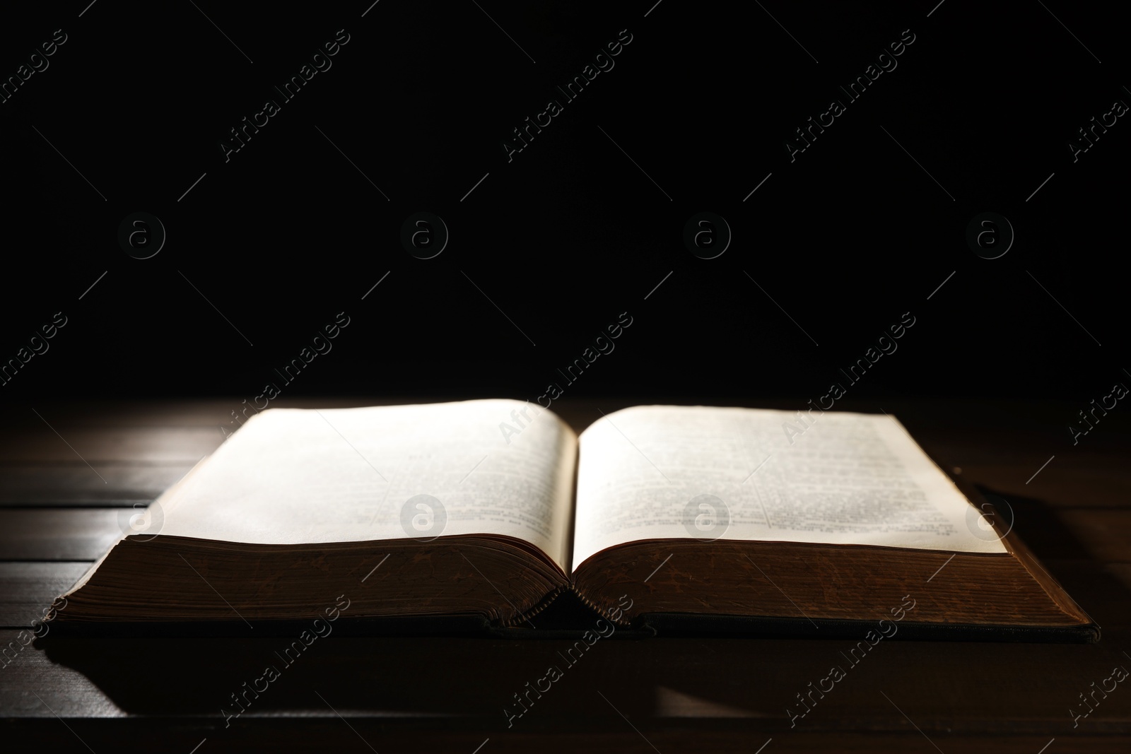 Photo of Open Bible on wooden table. Christian faith