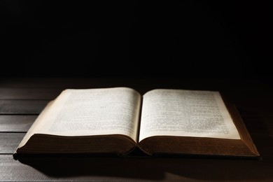 Photo of Open Bible on wooden table. Christian faith