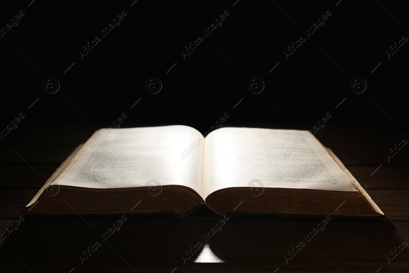 Photo of Open Bible on wooden table. Christian faith