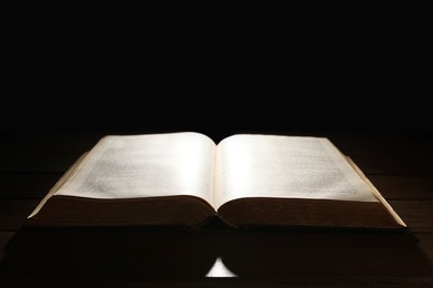 Photo of Open Bible on wooden table. Christian faith