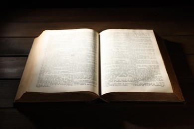 Photo of Open Bible on wooden table. Christian faith