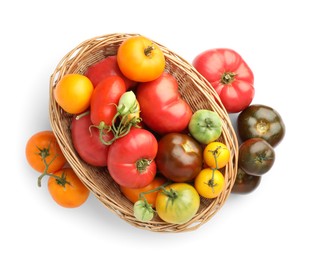 Photo of Different ripe tomatoes in basket isolated on white, top view