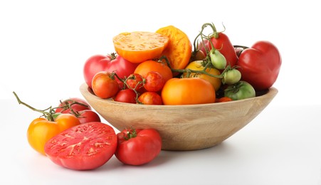 Photo of Different ripe tomatoes in bowl on white background