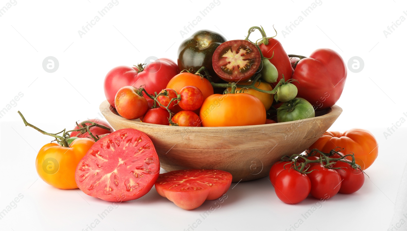 Photo of Different ripe tomatoes in bowl on white background