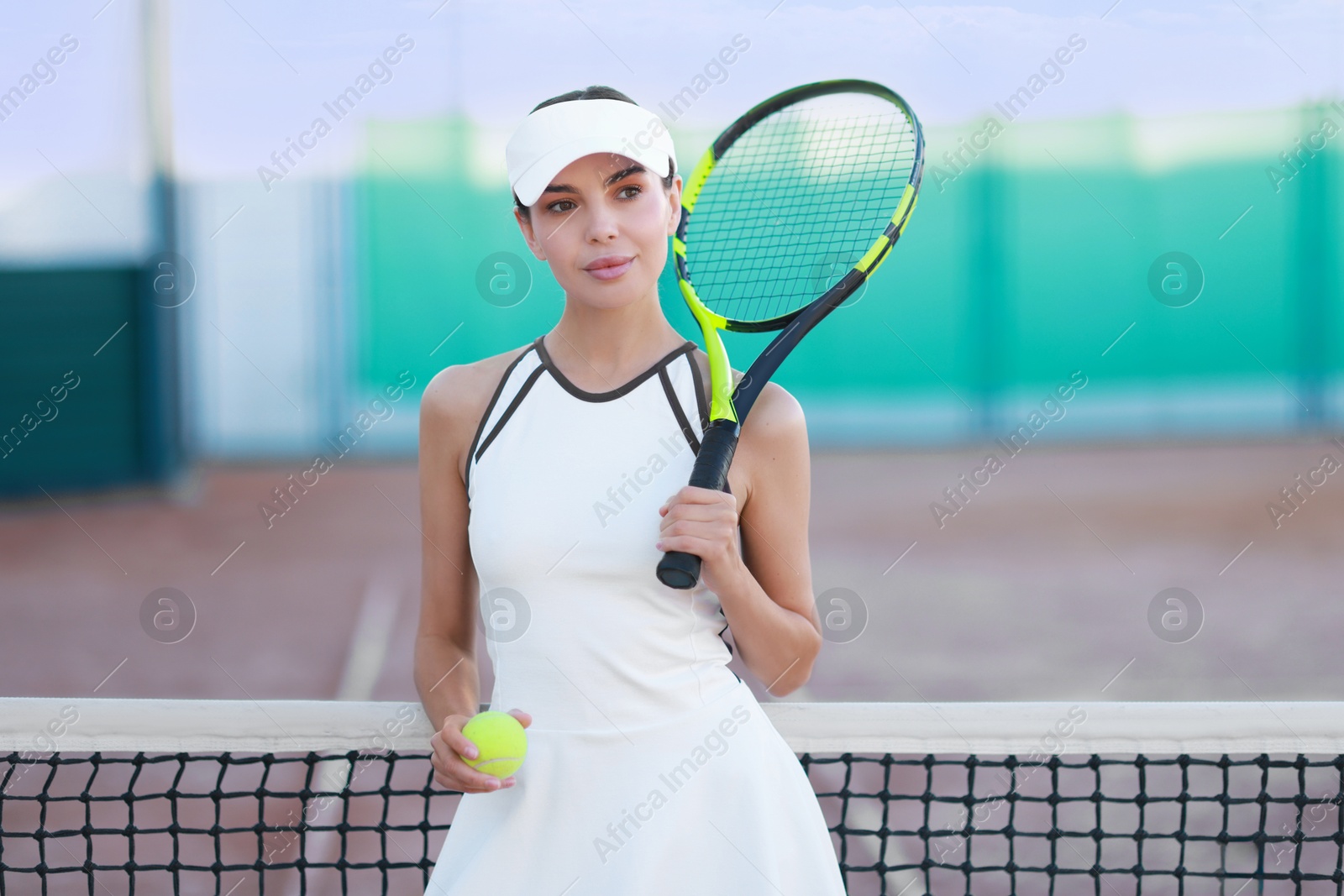 Photo of Beautiful woman with tennis racket and ball on court