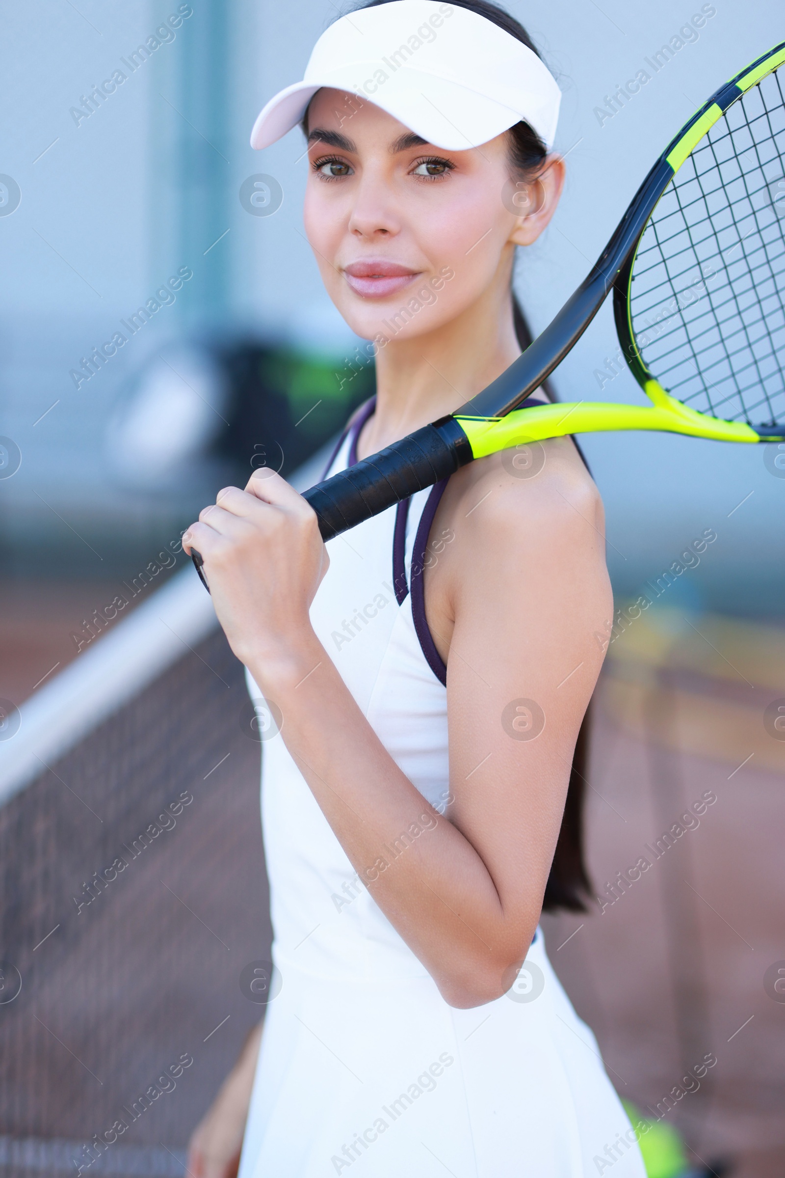 Photo of Beautiful woman with tennis racket on court