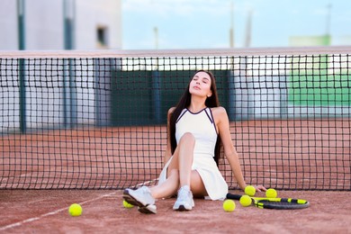 Photo of Beautiful woman in sportswear on tennis court