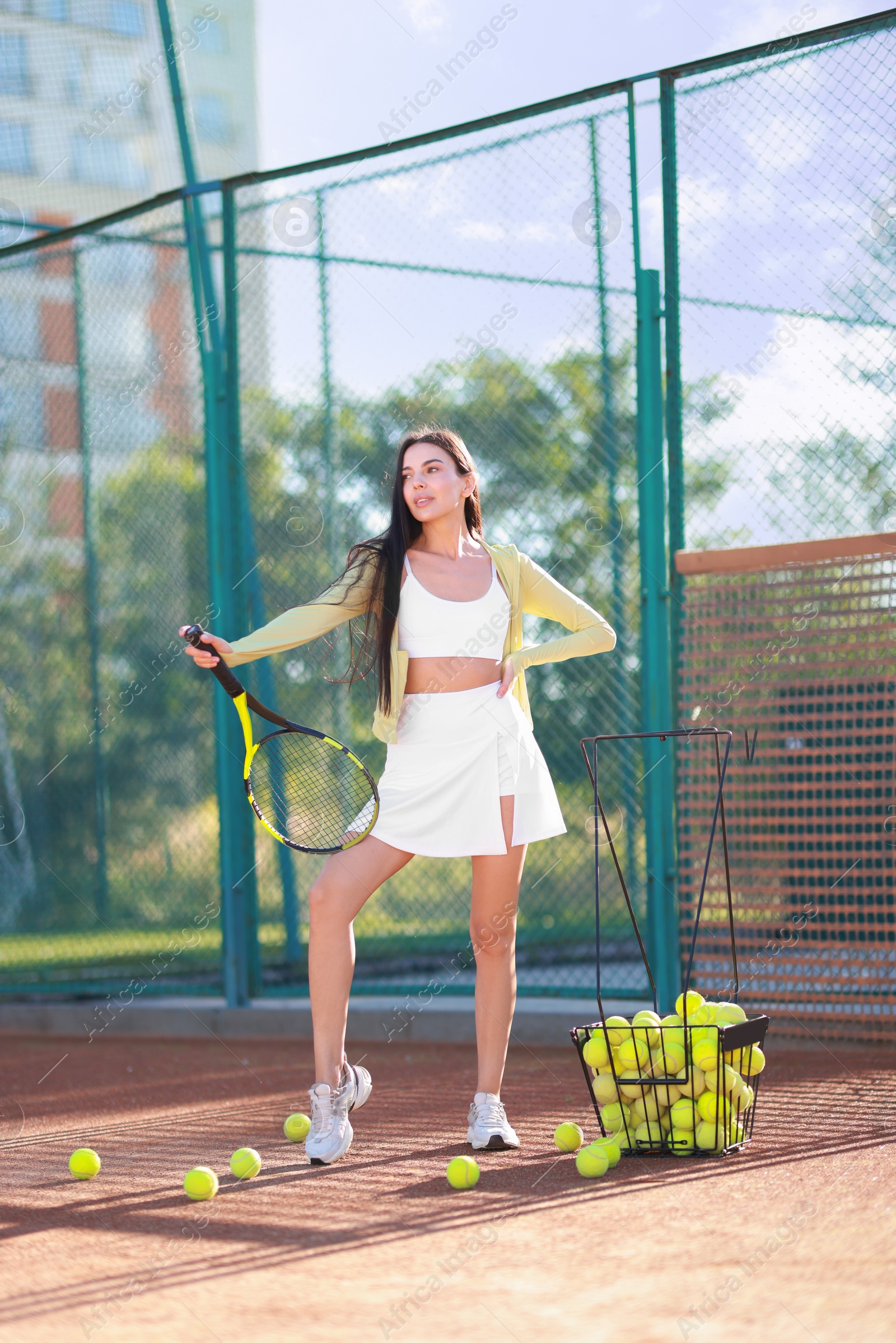 Photo of Beautiful woman with tennis racket on court