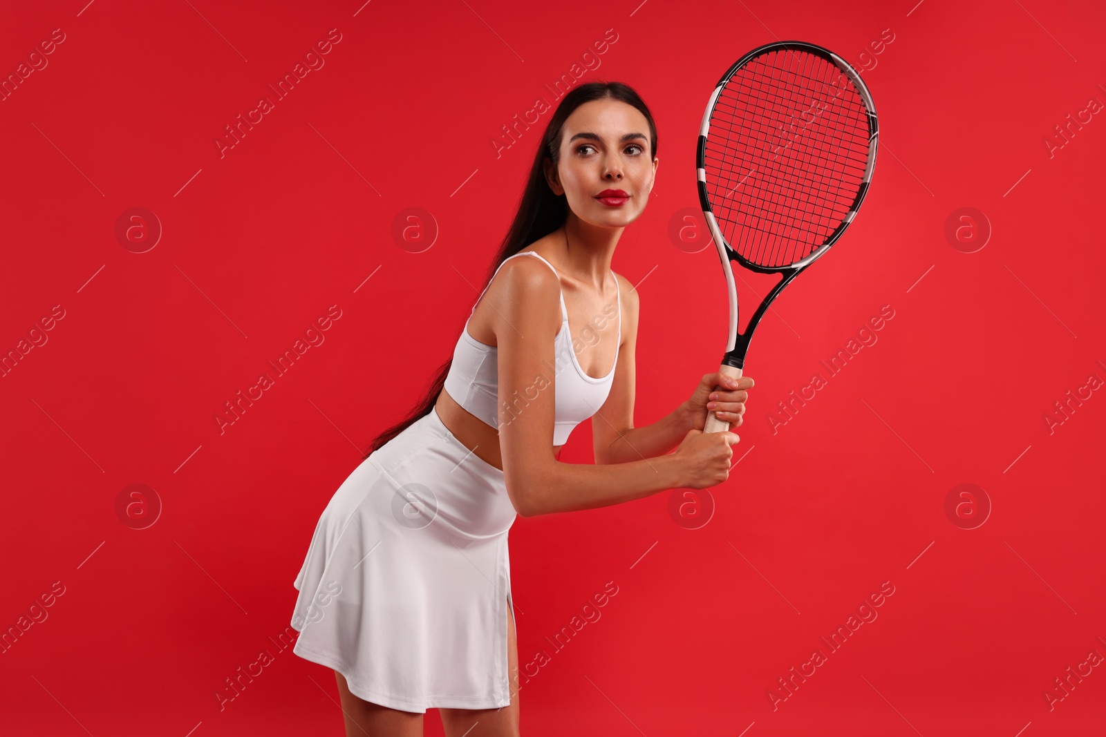 Photo of Tennis player with racket on red background