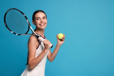 Happy tennis player with racket and ball on light blue background, space for text