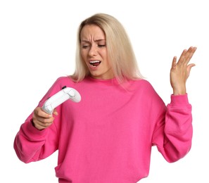 Emotional woman with controller on white background